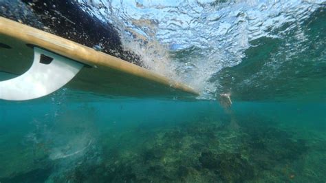 Underwater Slow Motion Athletic Surfer Paddling On His Surfboard In