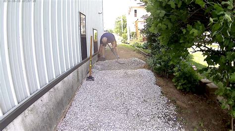 The shed is 12 ft deep by 16 ft wide and will be built starting on flat ground and extending out over a slope. Putting gravel on slope - YouTube