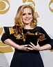 Adele held on to her Grammy Awards in the press room during the 2012 ...