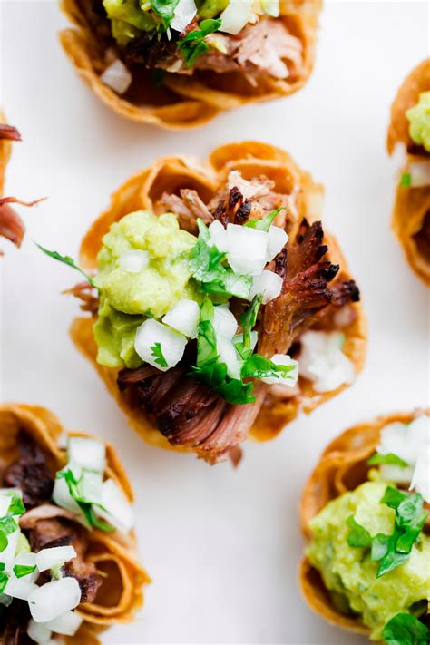 Six stuffed jalapeno peppers with cream cheese, lettuce and pico de gallo on the side. Slow Cooker Carnitas Taco Bites - A Beautiful Plate