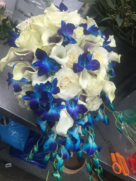 blue dendrobium orchids calla lilly and white rose cascading bouquet purple white wedding