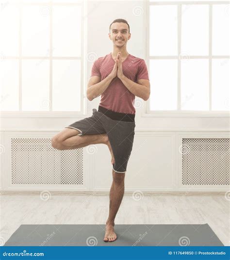 Young Man Training Yoga In Tree Pose Stock Photo Image Of Hobby