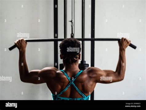 Portrait Of Muscular Woman Doing Pull Up Exercises For Back Muscles