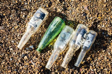 Glass Bottles On The Lake Shore Editorial Photography Image Of