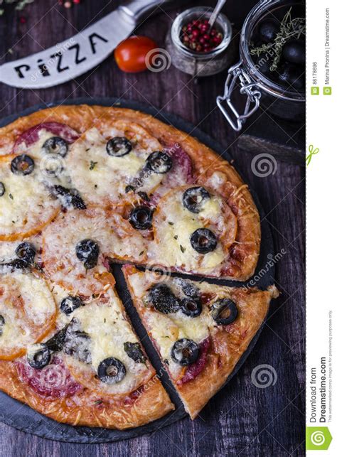 Pizza With Salami Mozzarella Olives And Basil Stock Photo Image Of