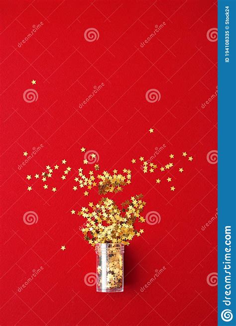 Vertical Photo Of Golden Star Glitter On Red Background Top View