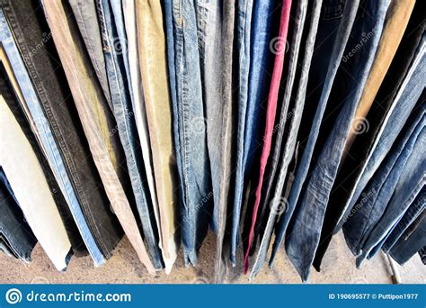 Jeans In Blue And Various Colors Arranged In Vertical Rows Stock Image