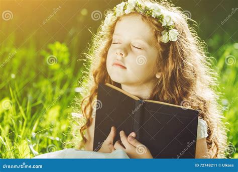 Little Girl Closed Her Eyes Praying Dreaming Or Reading A Book Stock