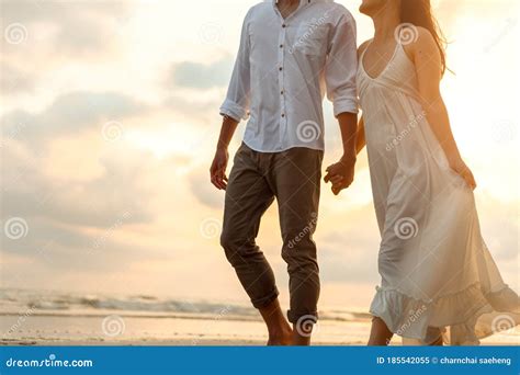 Romantic Couple Holding Hands And Walking On Beach Man And Woman In