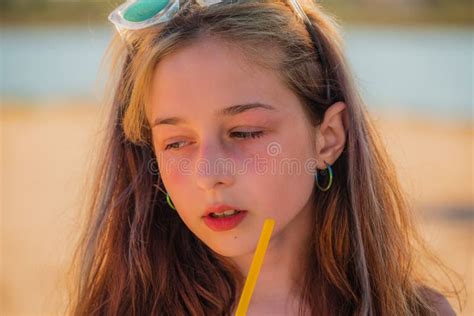 Girl In Sunglasses Drinks From A Straw A Drink On The Sea On The Beach