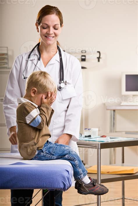 Doctor Giving Boy Checkup 855047 Stock Photo At Vecteezy