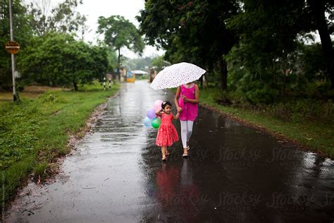 Sisters Walking On Wet Road In Rainy Season Together Del Colaborador