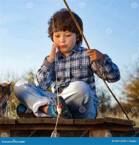 Happy Boy Go Fishing On The River With Pet One Children And Kitten Of