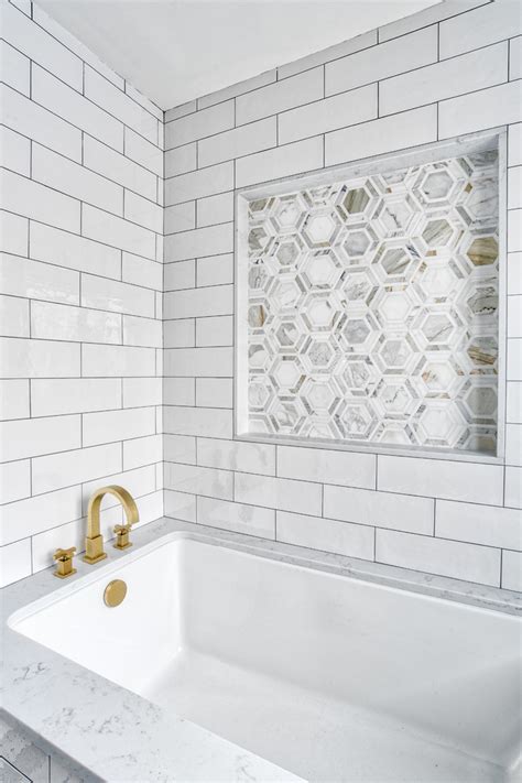 Bathrooms can be designed with entire walls, showers, and floors, covered in subway tiles. Undermount Tub with Brass Filler and Mosaic Tile Feature ...