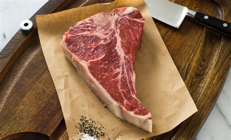 Watching someone whip out a friggin' hacksaw to prepare your food is incredibly satisfying and primal; How to Cook a 20oz T-Bone Steak Recipe - Debragga