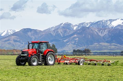 A Red Case Tractor And Contractor Doing Seasonal Spring Work On A New
