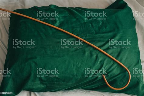 Rattan Cane On The Pillow Prepared For Spanking Domestic Discipline And