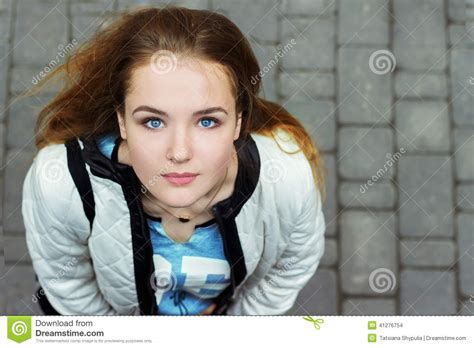 Young Beautiful Girl With Blue Eyes And Red Hair Walking