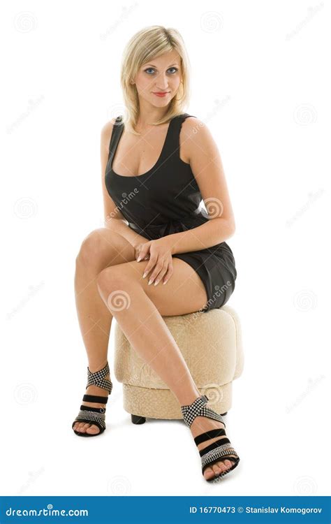 Beautiful Blonde Girl Is Sitting On An Ottoman Stock Image Image Of