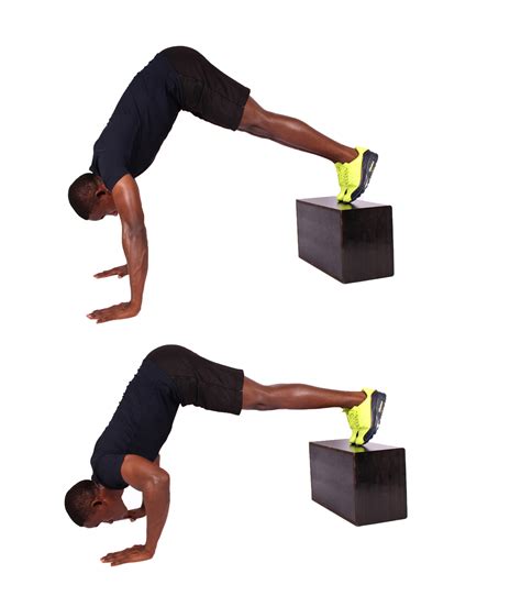 Fit Man Shows How To Do Pike Push Ups With Feet Elevated