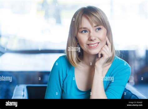 Portrait Of Beautiful Happy Satisfied Blonde Young Woman In Blue T