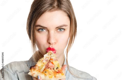 Pretty babe sexy woman eating big slice of pizza standing on white background Stock 写真 Adobe