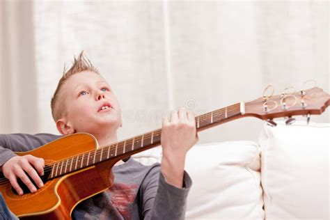 Little Boy Playing Guitar At Home Stock Image Image Of Expressing