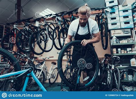 Young Mechanic Repairs Bicycle In Bike Workshop Stock Photo Image Of