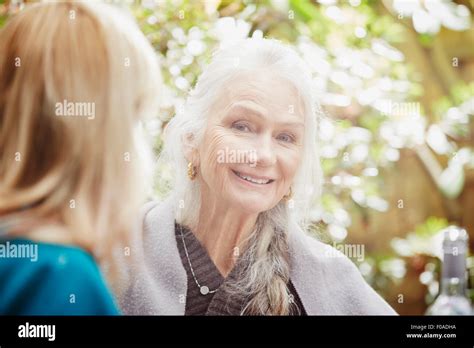 Senior Woman With Grey Hair In Garden Portrait Stock Photo Alamy