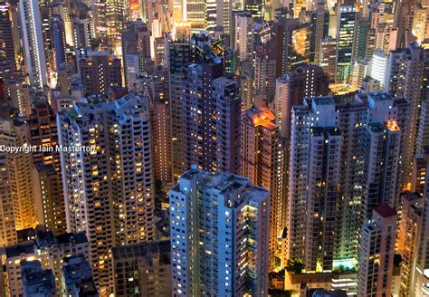 Night View Of Dense High Rise Apartment Buildings On Hong Kong Island