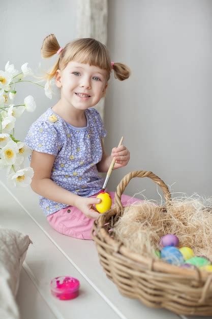 Premium Photo Little Girl Coloring Easter Eggs