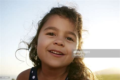 mixed race girl smiling outdoors photo getty images