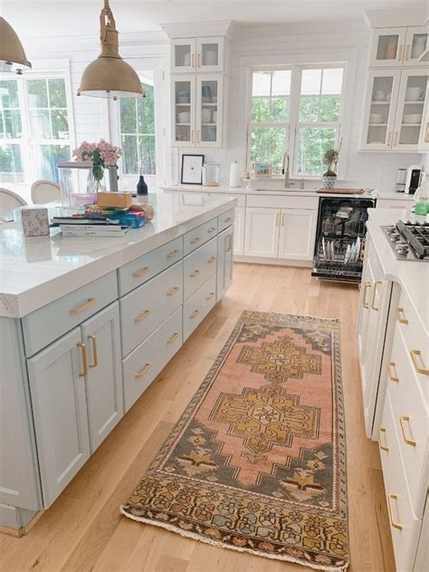 A Kitchen With An Antique Rug On The Floor