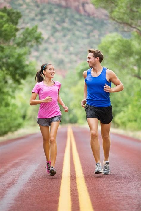 Two People Jogging For Fitness Running On Road Stock Image Image Of