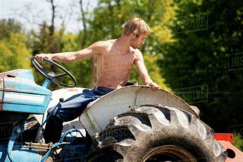 Shirtless Farmer On Tractor Stock Photo Dissolve