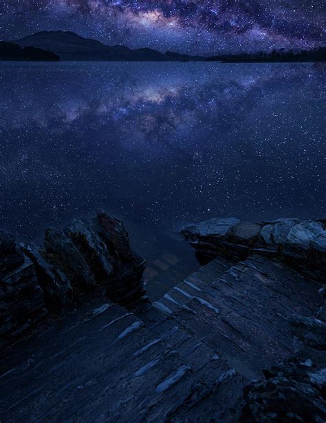 Epic Vibrant Milky Way Composite Image Over Landscape Of Loch Lo
