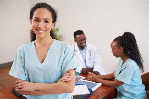 Portrait Of Smiling Nurse Standing In Medical Conference Room With
