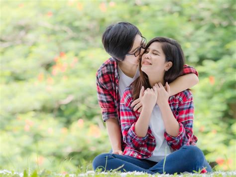 Asian Female Couples Lgbt Sitting And Relax In The Garden And Embrace