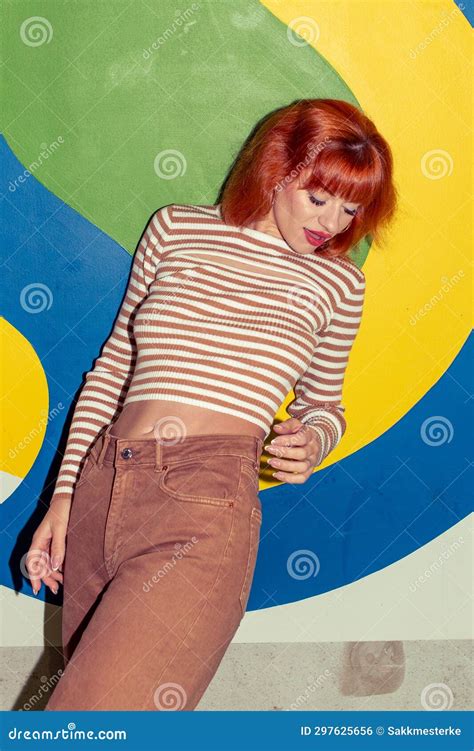 Young Stylish Redhead Caucasian Woman In Retro Style Of 70s Posing At