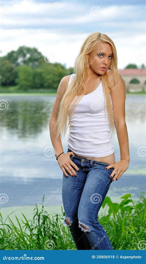 Young Blonde Woman In White Tank Top And Jeans Royalty Free Stock