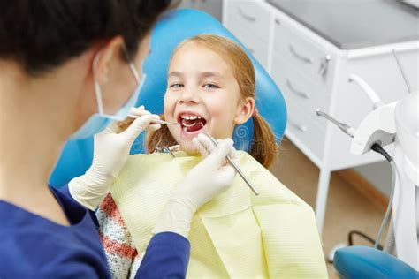 Pediatric Dentistry Dentist Treats Teeth Of Little Girl Stock Photo