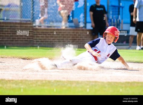 Little League Baseball Player Sliding Home Stock Photo Alamy