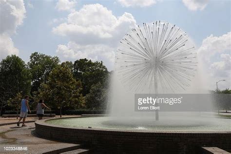 People Walk Past The Gus S Wortham Memorial Fountain By Buffalo