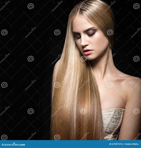 Beautiful Blond Girl With A Perfectly Smooth Hair And Classic Make Up