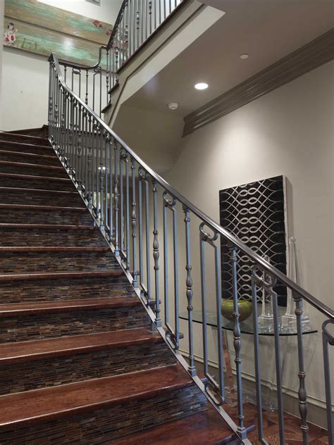 Magnificent iron art handmade railing by son of odin iron works. Wrought Iron, wood and tile staircase #platinumseries #markmolthan #home #luxury | Show home ...
