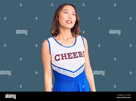 Young Beautiful Chinese Girl Wearing Cheerleader Uniform Looking Away