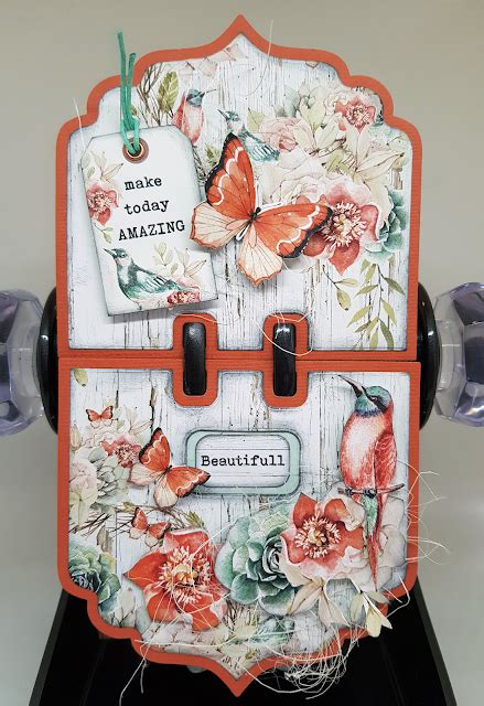 A Close Up Of A Box With Flowers And Butterflies On The Front Attached