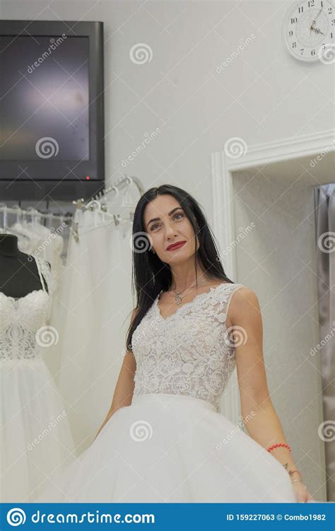 Beautiful Girl Tries On A Wedding Dress In A Bridal Salon Stock Image