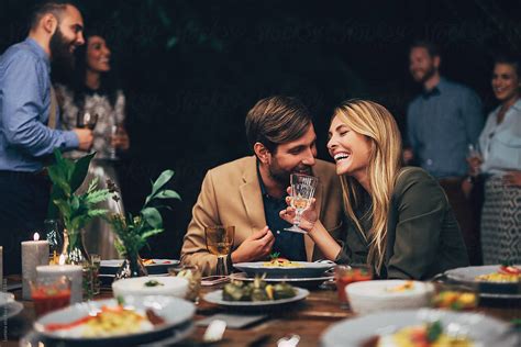 Couple Having Fun At The Dinner Party Del Colaborador De Stocksy