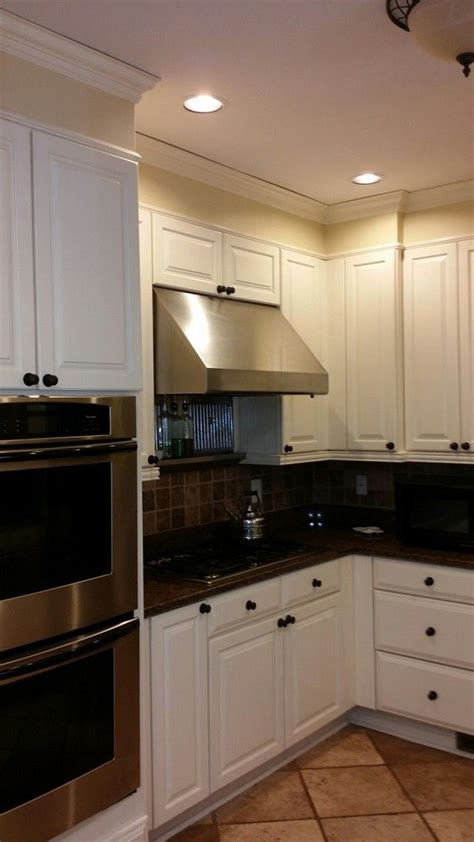 Wall cabinets stacked as base and tall cabinets from floor to ceiling create an accent wall that can house everything from cookbooks to appliances. Simple soffit that's not a perfect color match to cabinets below. I've been wondering how to p ...